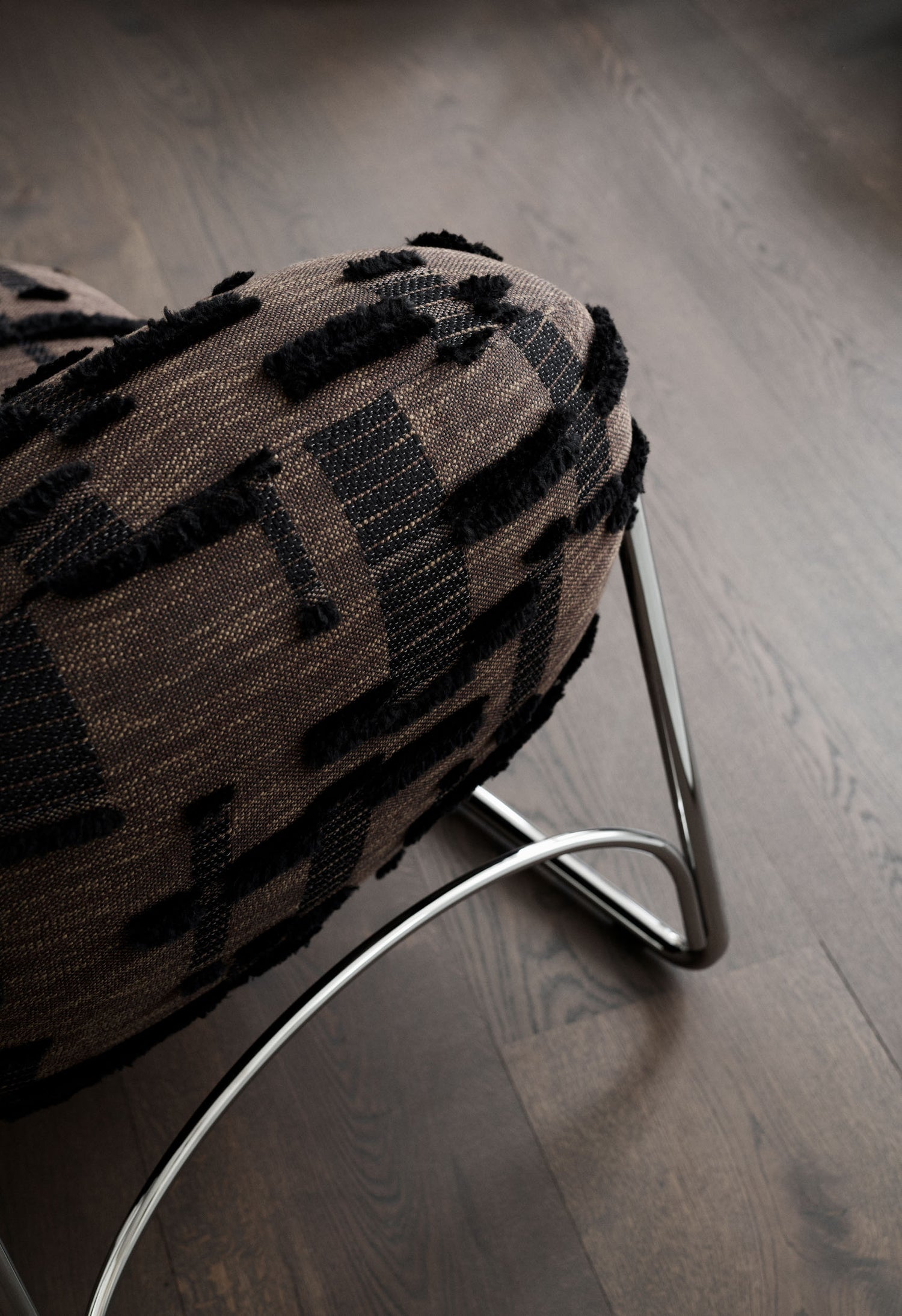 Boho Chair with textured brown upholstery on a wooden floor