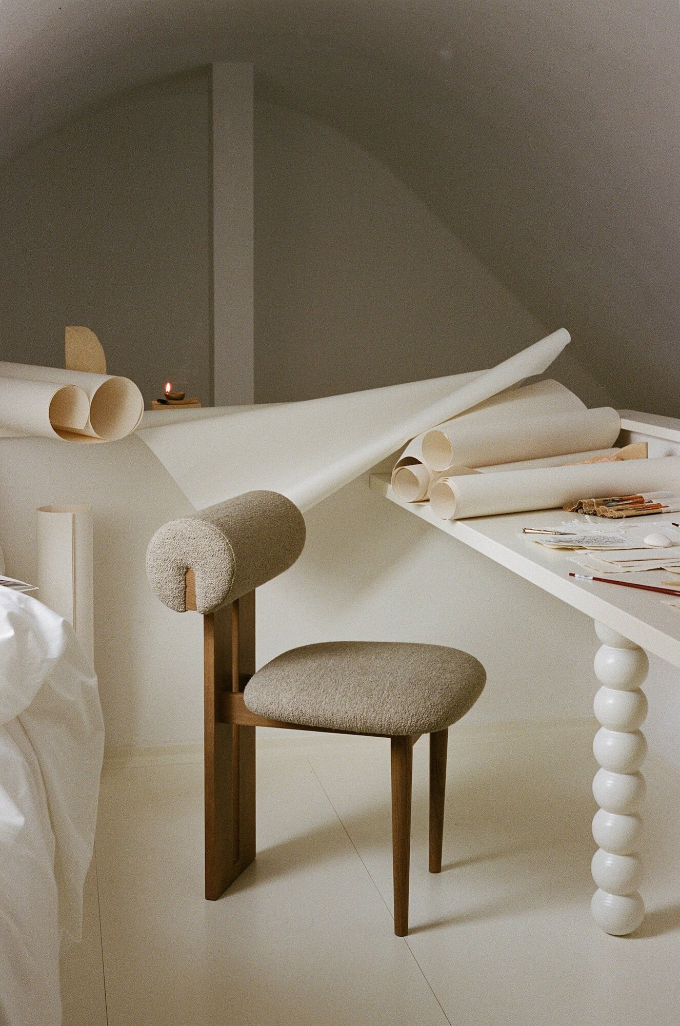 Hippo Chair in a room with a desk and rolled-up paper