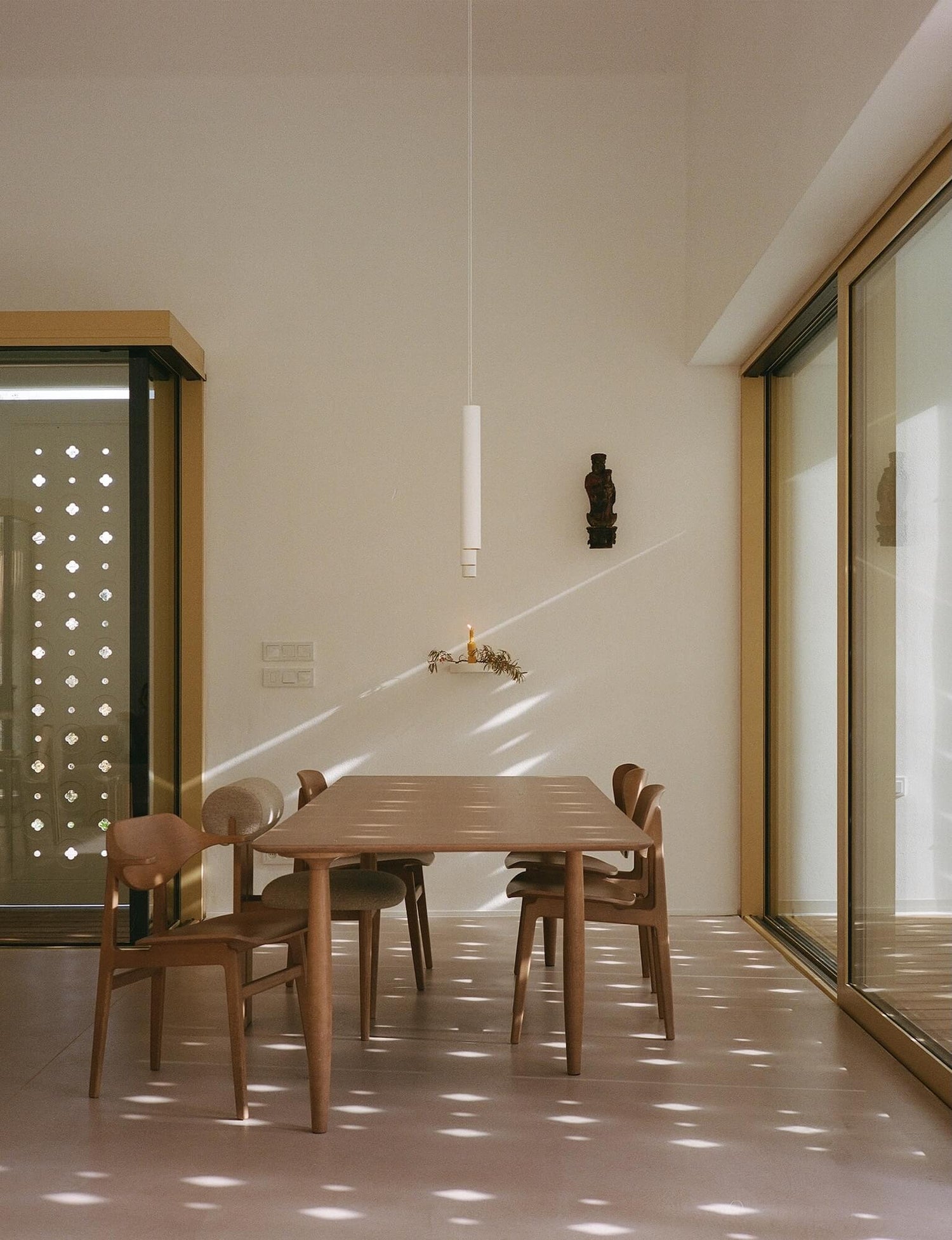 Dining area with wooden table and chairs in a well-lit room.